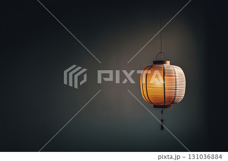 single paper lantern glows softly in dark 131036884