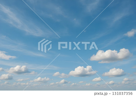 A vast blue sky adorned with soft, fluffy white clouds creates a tranquil and airy atmosphere A vast blue sky adorned with soft, fluffy white clouds creates a tranquil and airy atmosphere 131037356