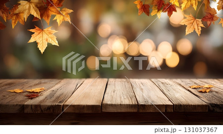 Rustic wooden table adorned with autumn maple leaves and a blurred background. Rustic wooden table adorned with autumn maple leaves and a blurred background. 131037367