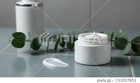Luxurious white cream jar with eucalyptus leaves, perfect for natural skincare and beauty. Luxurious white cream jar with eucalyptus leaves, perfect for natural skincare and beauty. 131037651