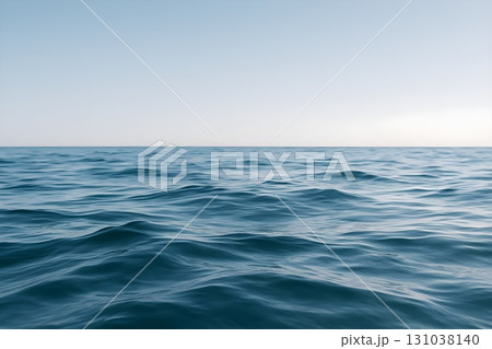 A tranquil seascape showcasing gentle ocean waves under a clear blue sky. 131038140