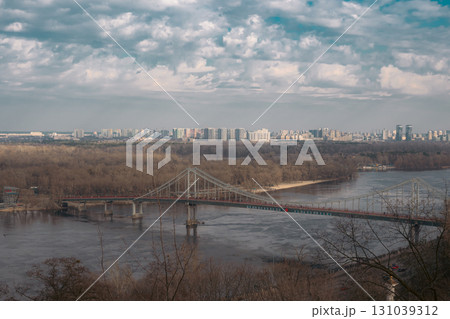 KYIV, UKRAINE Pedestrian bridge over Dnypro river in Kyiv KYIV, UKRAINE Pedestrian bridge over Dnypro river in Kyiv 131039312
