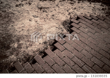 Where Nature Meets Structure Crumbling Brick Path and Dirt 131039335