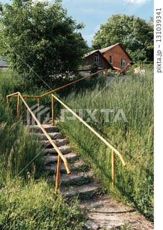 Old Concrete Stairs with Orange Handrails in Countryside Old Concrete Stairs with Orange Handrails in Countryside 131039341