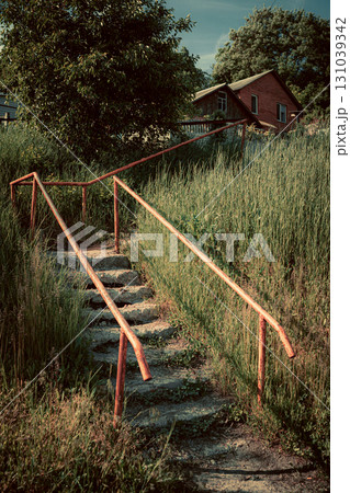 Old Concrete Stairs with Orange Handrails in Countryside Old Concrete Stairs with Orange Handrails in Countryside 131039342