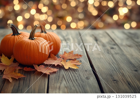 Fall pumpkins on wooden table with autumn leaves and lights 131039525