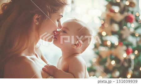 Mother and baby sharing a tender moment in a cozy holiday setting with Christmas tree lights Mother and baby sharing a tender moment in a cozy holiday setting with Christmas tree lights 131039939