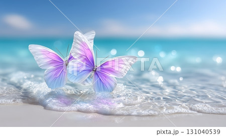 Two vibrant butterflies on a pristine white sand beach with gentle ocean waves and sparkling water 131040539