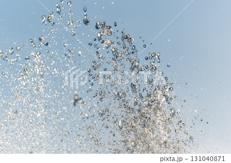 Splashes and jets of water against light background. 131040871