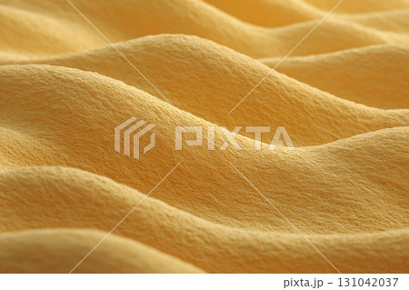 Soft yellow fabric with close up textured surface and gentle folds creating warm flowing pattern and cozy tactile feel 131042037