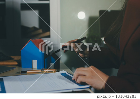 Customer signing a real estate contract in real estate agency. Customer signing a real estate contract in real estate agency. 131042283