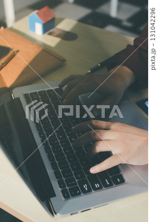 Customer signing a real estate contract in real estate agency. Customer signing a real estate contract in real estate agency. 131042296