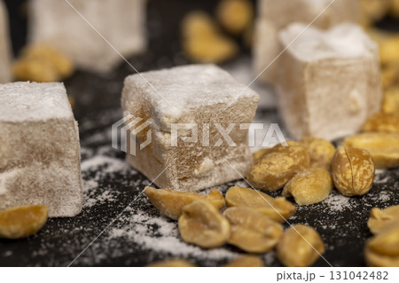 oriental sweets Turkish delight with peanuts on a board oriental sweets Turkish delight with peanuts on a board 131042482