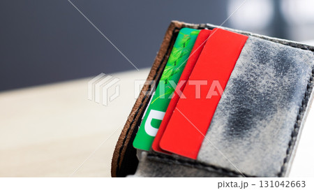 A stylish wallet that features a green card with the letter d on it 131042663