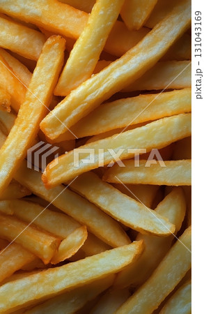 Crispy Golden French Fries Piled Together in a Delicious, Tempting Display at a Fast Food Restaurant 131043169