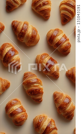 Croissants Arranged Beautifully on a Beige Background for a Delightful Visual Feast. Croissants Arranged Beautifully on a Beige Background for a Delightful Visual Feast. 131043191