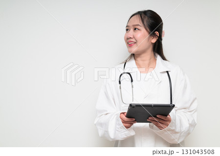 Portrait of young Asian healthcare worker woman doctor in lab coat using digital tablet computer Portrait of young Asian healthcare worker woman doctor in lab coat using digital tablet computer 131043508