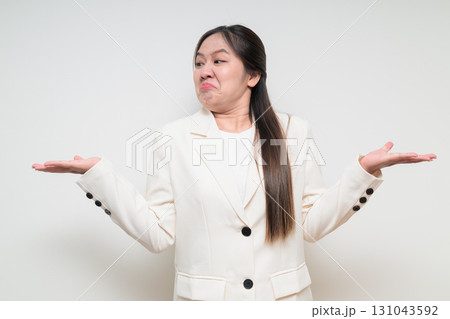 Portrait of young Asian woman wearing suit looking stressed and annoyed 131043592