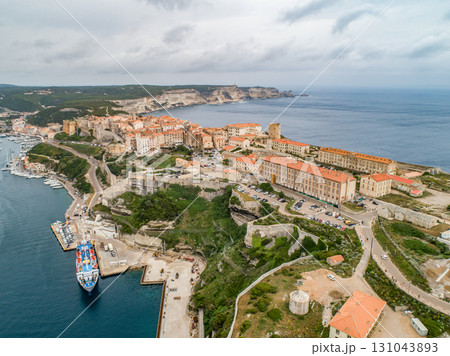 Aerial view marina cape Bonifacio south Corsica France citadel on rocky promontory on wild white limestone cliffs 131043893