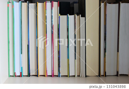 Hardback Books Of Different Thicknesses And Formats On A Wooden Shelf Texture Background Hardback Books Of Different Thicknesses And Formats On A Wooden Shelf Texture Background 131043898