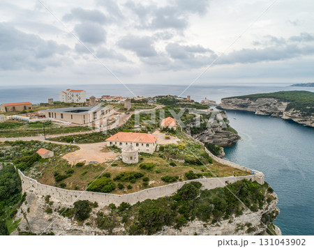 Aerial view marina cape Bonifacio south Corsica France citadel on rocky promontory on wild white limestone cliffs 131043902