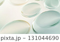 Translucent oval forms overlapping, generating ethereal geometric composition with soft luminosity, representing contemporary minimalist aesthetic and visual serenity 131044690