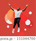 Energetic african american athlete jumping, arms raised, exuding joy against vibrant red studio backdrop with geometric shapes 131044700