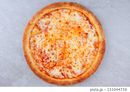 Classic Cheese Pizza with Melted Mozzarella and Tomato Sauce on Golden Crust over Gray Stone Background Classic Cheese Pizza with Melted Mozzarella and Tomato Sauce on Golden Crust over Gray Stone Background 131044739