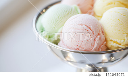 Polished vintage silver ice cream dish showcasing pastel scoops 131045071