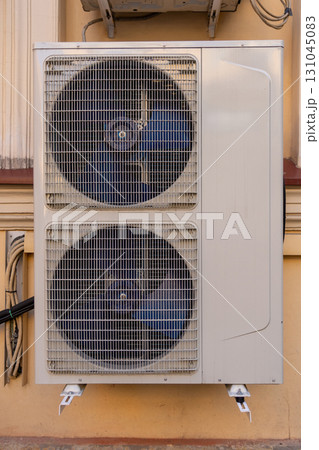 industrial C air conditioner is installed on the facade of a house or office. industrial C air conditioner is installed on the facade of a house or office. 131045083