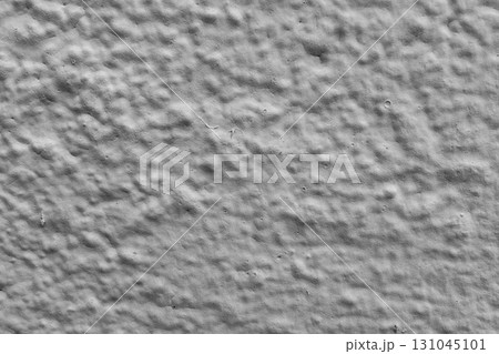 Close-up textured gray concrete wall surface with subtle patterns and details 131045101