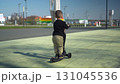 A Happy Child Riding a Bright Scooter in the Open Park, Enjoying an Adventurous Day 131045536