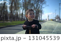 A Joyful Young Child Happily Riding a Colorful Scooter in the Park, Embracing Fun and Adventure 131045539