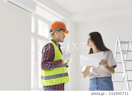 Client And Worker Disagreeing Over Home Renovation Plans 131045711