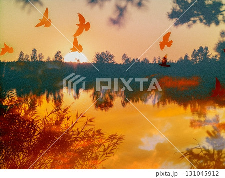 Birds fly over a serene lake reflecting a stunning sunset. A serene sunset reflects on a tranquil lake, pond with silhouettes of birds soaring in sky. 131045912