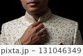 Blank wedding ring barely visible, adjusting sherwani collar, isolated Blank wedding ring barely visible, adjusting sherwani collar, isolated 131046349