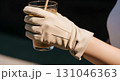 Blank suede gloves worn mockup, hand holding iced coffee, isolated close-up Blank suede gloves worn mockup, hand holding iced coffee, isolated close-up 131046363