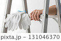 Blank safety gloves gripping ladder rung, isolated Blank safety gloves gripping ladder rung, isolated 131046370