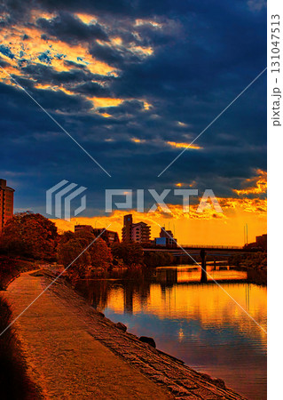 夕焼けに染まる川面 131047513