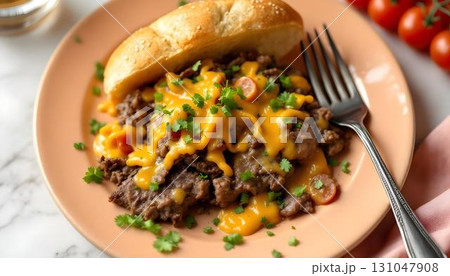 A tempting burger with melted cheese on a plate, representing summer flavors and the Philly cheesesteak tradition 131047908