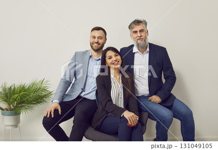 Group of smiling business workers posing together in office Group of smiling business workers posing together in office 131049105