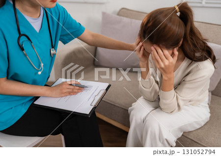 Mental health professional offers empathetic psychological support to distressed Asian adult woman home consultation session therapy care Mental health professional offers empathetic psychological support to distressed Asian adult woman home consultation session therapy care 131052794