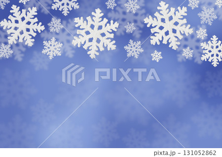 Christmas blue background of white snowflakes flying in the air. Holiday card for New Year and Christmas with space for greetings, labels and your design. 131052862