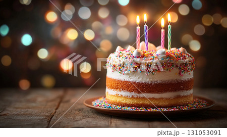 birthday cake with colorful sprinkles and candles with blur festive background 131053091