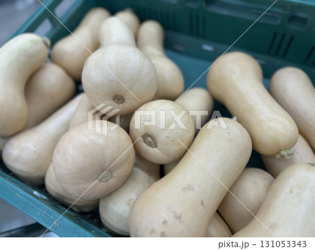 Fresh butternut squash piled in a green plastic crate ready for harvest and cooking Fresh butternut squash piled in a green plastic crate ready for harvest and cooking 131053343