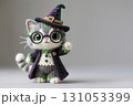 Cute little cat crochet doll wearing witch costume. 131053399