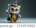 Cute owl crochet doll wearing colorful witch costume. 131053402