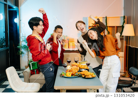 Friends celebrate Christmas with gift exchanges, festive food, and laughtera perfect scene for holiday and New Year 131053420