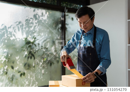 Business professional sealing boxes for e-commerce, highlighting the importance of packaging in online sales. Business professional sealing boxes for e-commerce, highlighting the importance of packaging in online sales. 131054270