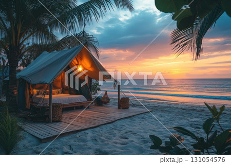 Tropical beach camping a romantic sunset adventure under serene skies 131054576